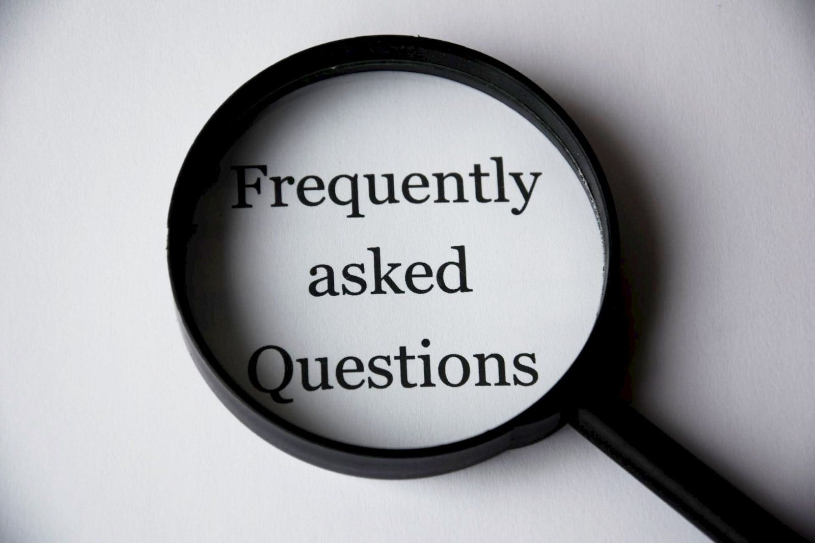 FAQs. Frequently Askked Questions. Black Magnifying Glass