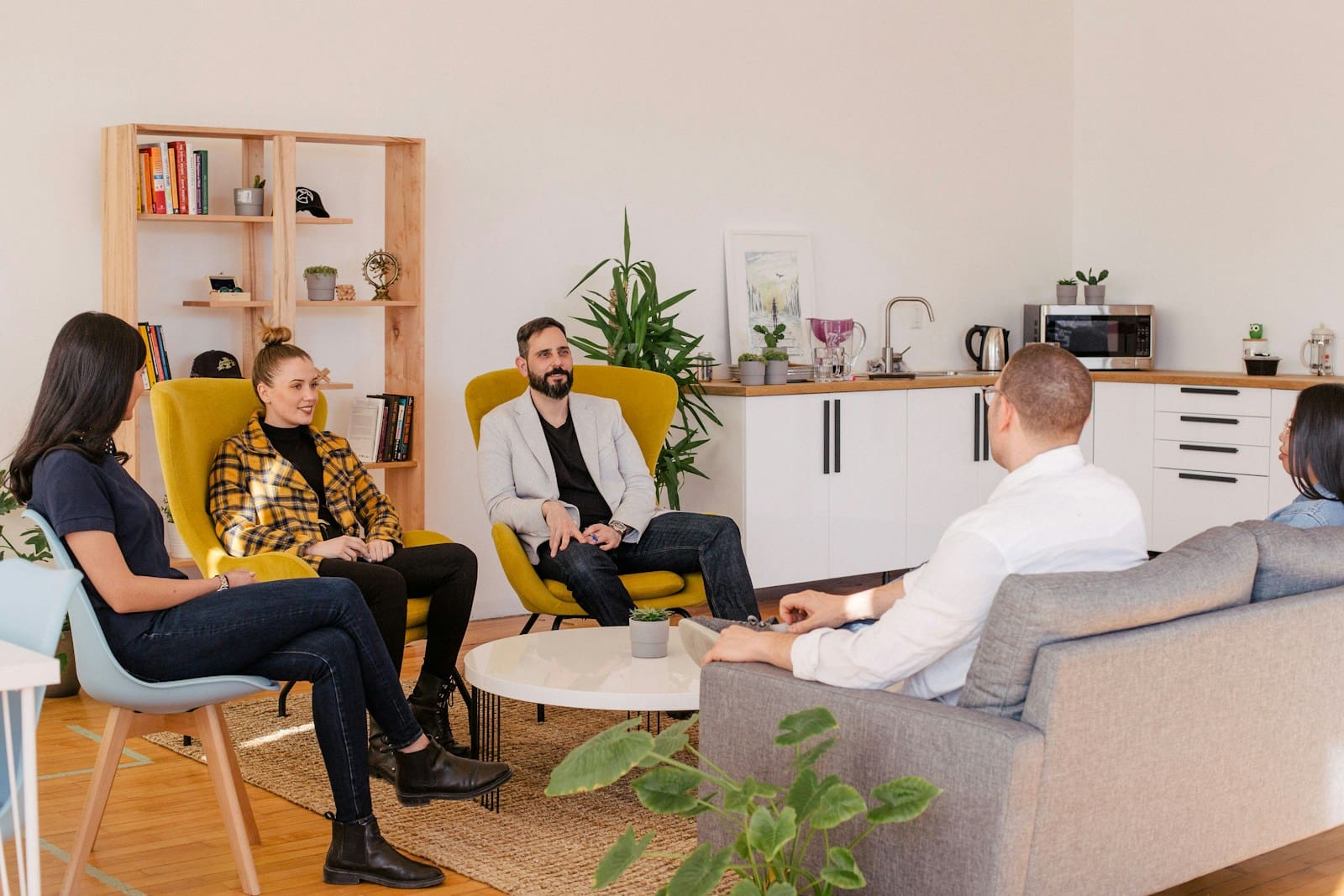4 people discussing business issues. Small Business Management Consulting