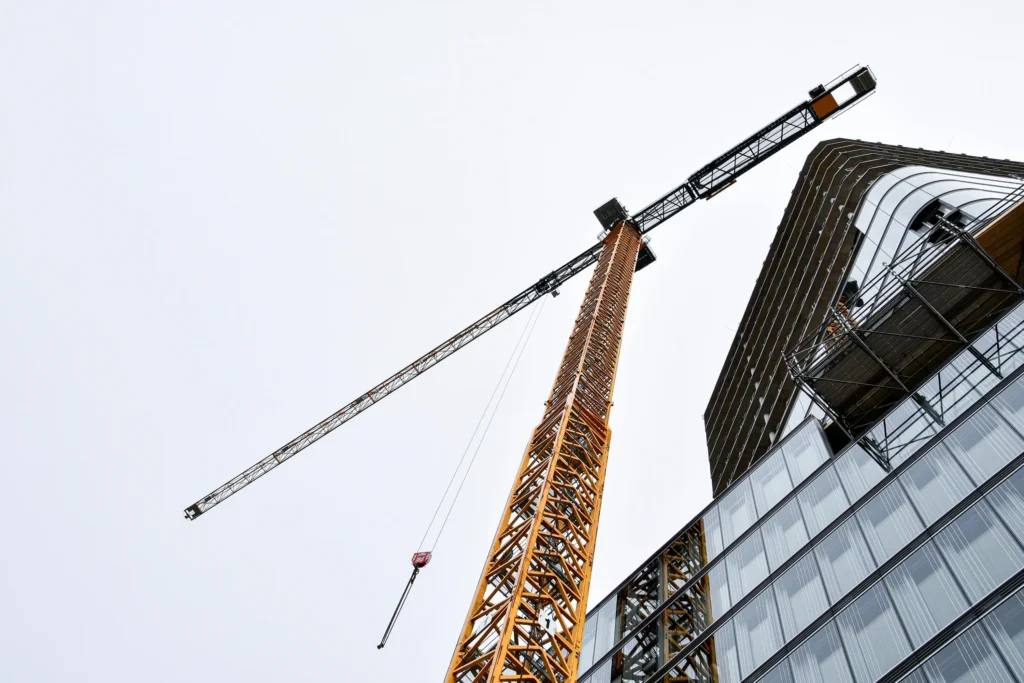 Crane above a building. Liquidated damages in construction contracts. Industries in Australia where we support our clients
