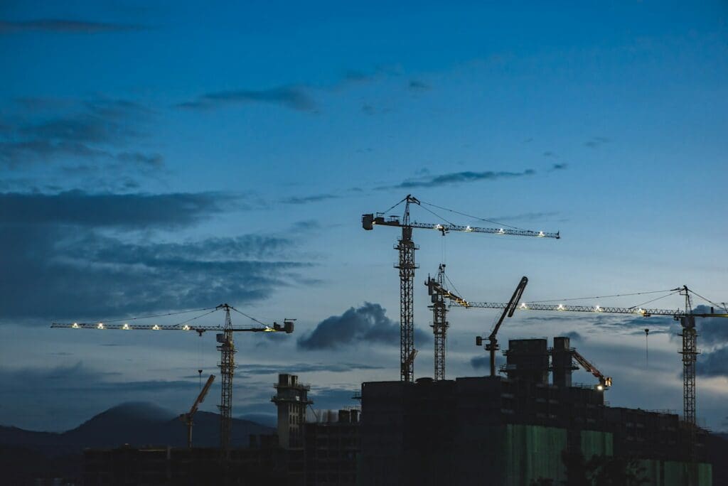Cranes on a construction site above a building. Understanding the construct only contract. Construction Lawyer