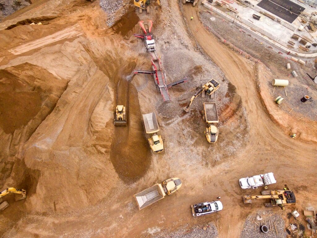 Aerial photography of dump trucks. How to resolve construction dsputes. Construction Lawyer