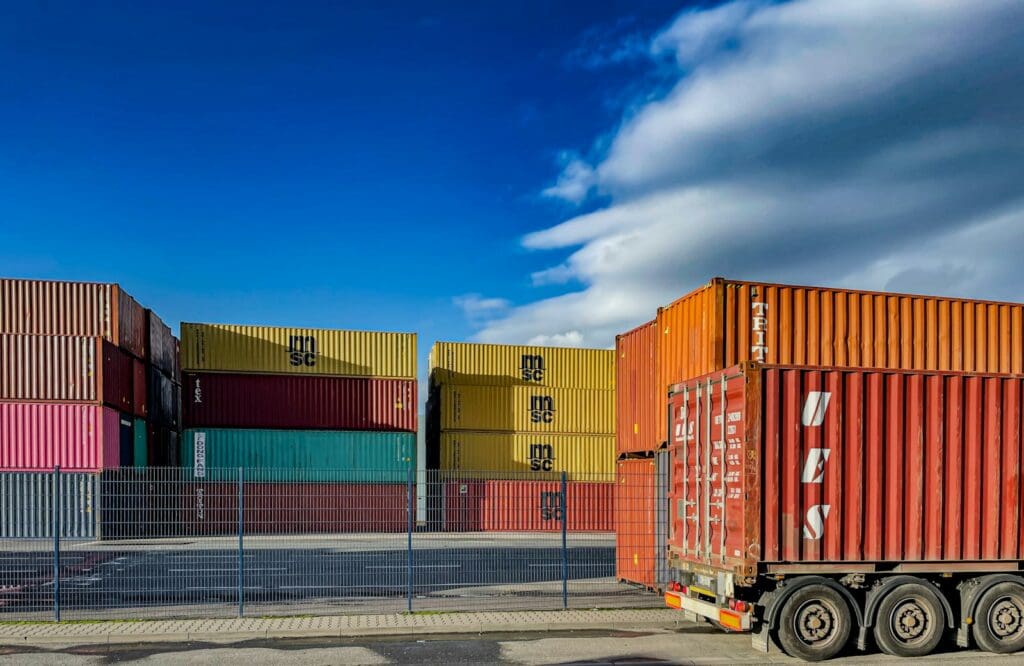 Medium Business 1 A truck is parked in front of a bunch of shipping containers. How to improve contracting in your business. Medium business. Construction Lawyer. AS2124-1992. AS2124