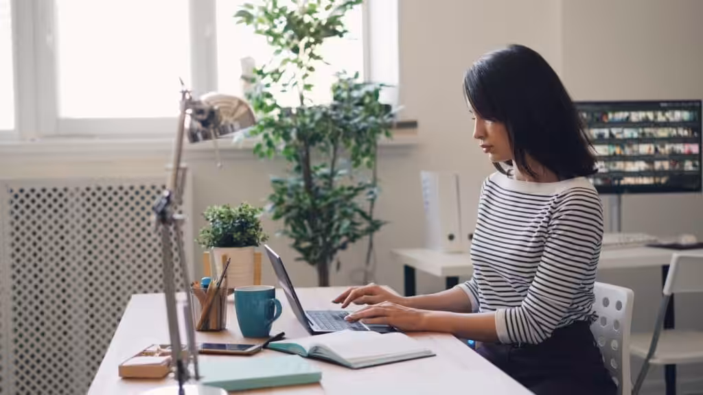 A professional Accountant or Commercial Lawyer sitting at a desk using a laptop computer. Structuring Your Business Do You Need an Accountant or a Lawyer or both?