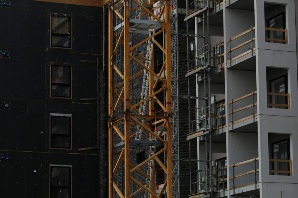 Construction Law 8 Crane attached to a construction building. Construction law. Construction Lawyer