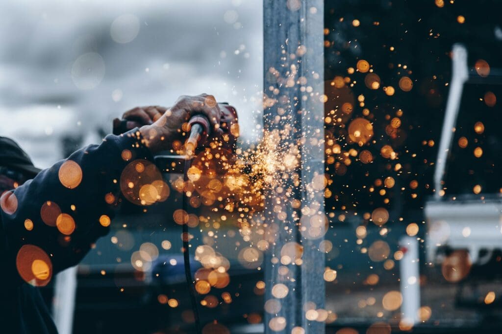 Construction Law 10 Construction worker grinding metal. AS2124-1992. AS2124