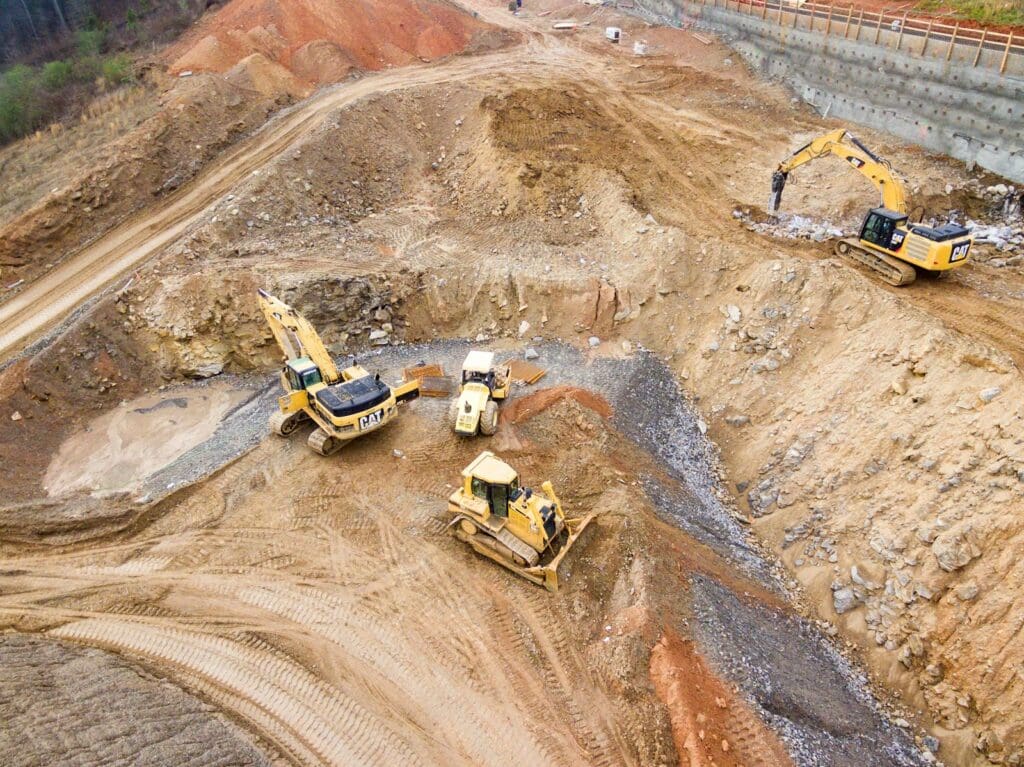 Construction Lawyers | Blaze Business & Legal 2 Four heavy excavation equipment in a quarry. Construction Lawyers