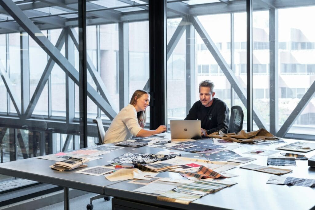 How to work better with a Management Consultant 1 Lawyer and Management Consultant and client sitting at meeting room table. Business Management Consultant. Legal Services