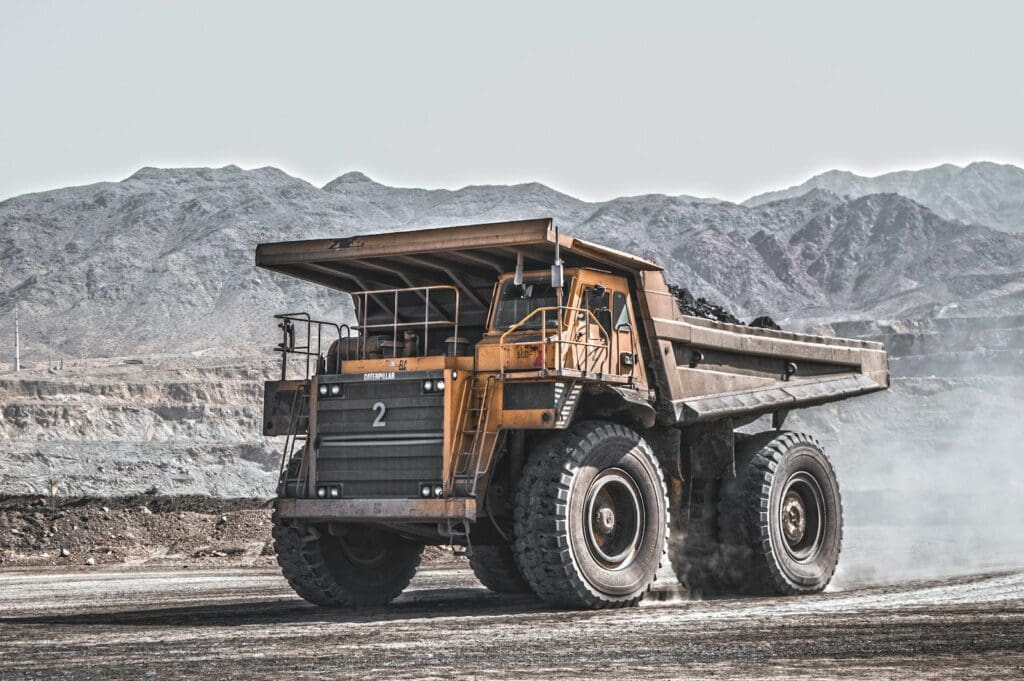 Business Loan Calculator - Should My Business Take Out A Loan? 7 Yellow and black heavy dump truck equipment at a mining site. AS2124-1992. AS2124. Business Loan Calculator Quiz