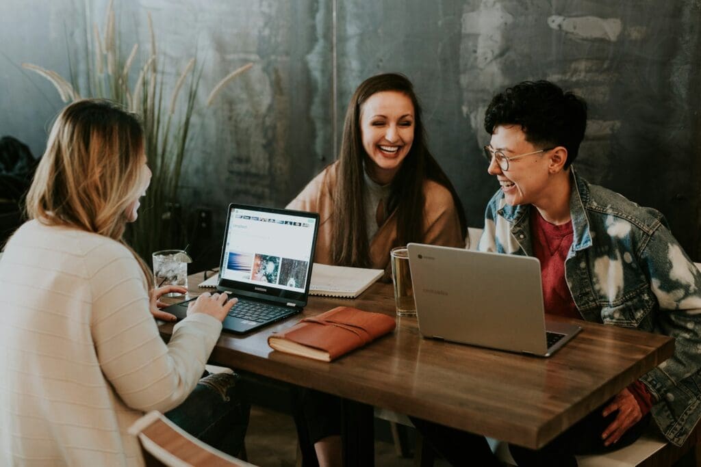 Get Business Management Consulting and Transform Your Company 4 Consultants and clients sitting in front of a table laughing together. Small Business Management Consultant. Business Management Consulting. What is Business Advisory