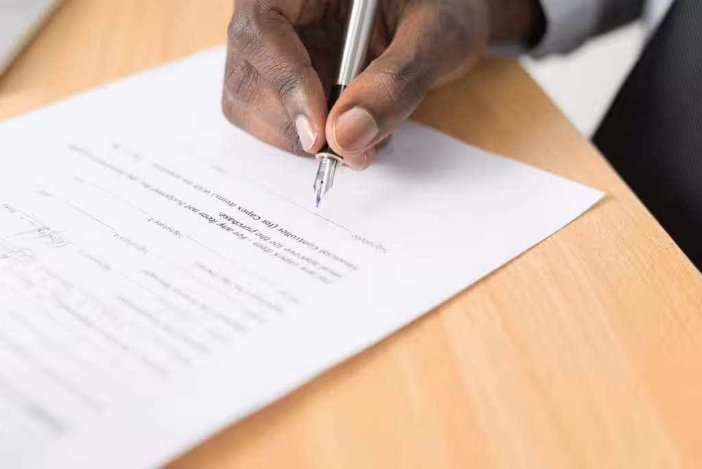 Person signing a contract. Contract Lawyer. Legal Services