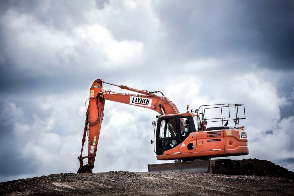 Construction Lawyers | Blaze Business & Legal 6 Orange excavator at a construction site. Construction Lawyers.