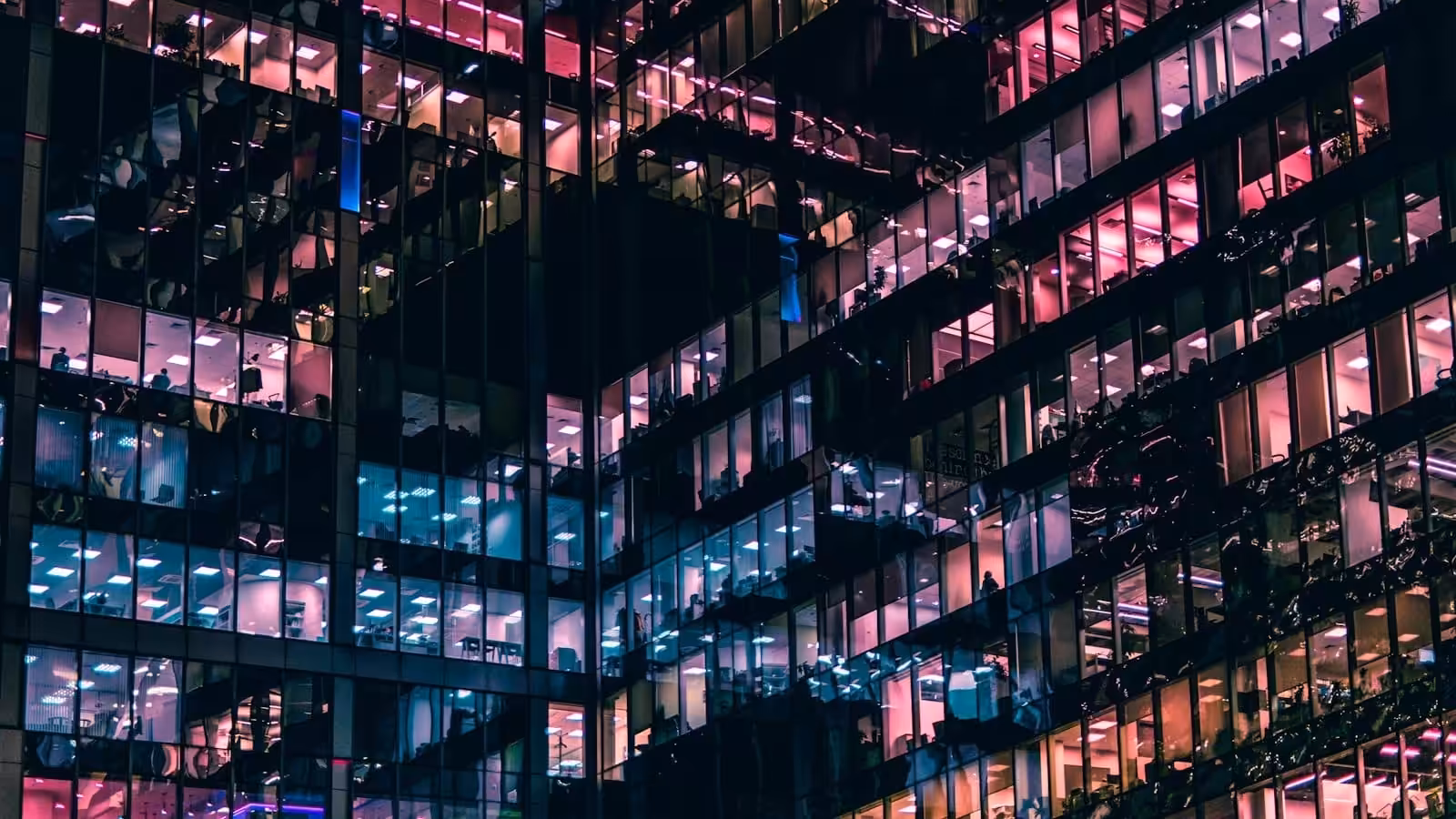 Business building with people in it during nighttime. Business Restructuring at Blaze Business & Legal