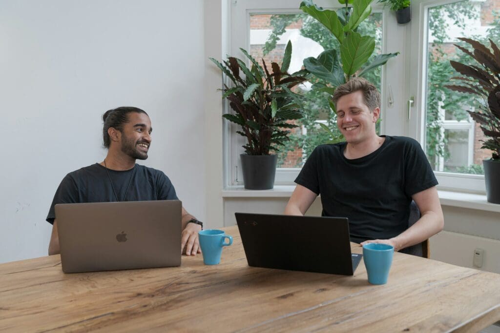 Business Growth Strategist – The Expert Approach to Growing Your Company 2 Two men sitting at a brown table with laptops. Startup Funding Landscape. Small Business Management Consulting. Business Growth Consultant. Business Growth Strategist.