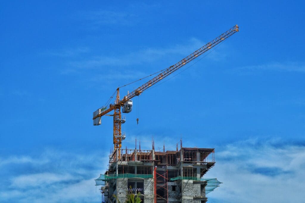 Construction Law 1 Crane on a building. Construction Law. Construction Laws.