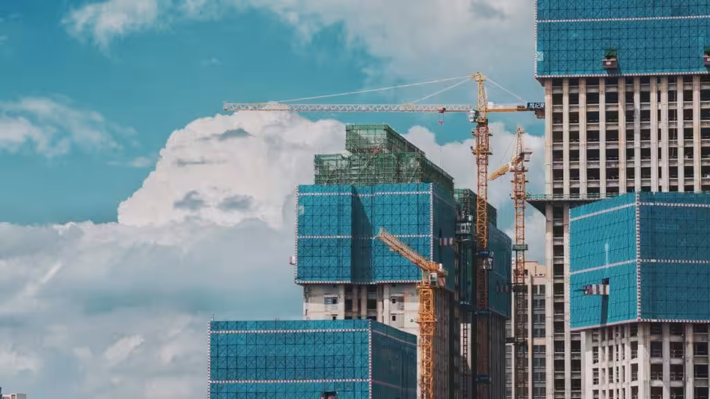 Cranes around a building under construction. How to review a construction contract. How to review a construction agreement.