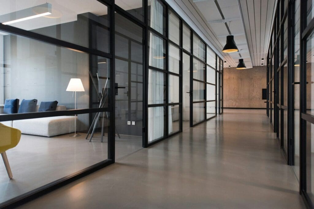 Office hallway between glass-panel doors. Commercial Lease Review