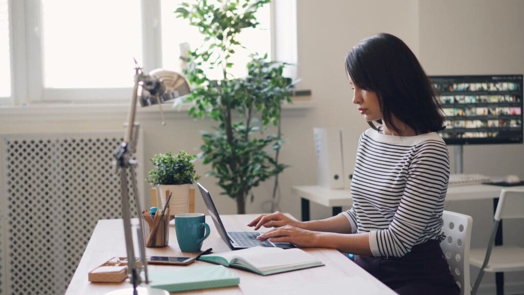 How our Contract Review Lawyer can save you money 2 Contract Review Lawyer sitting at a desk using a laptop computer