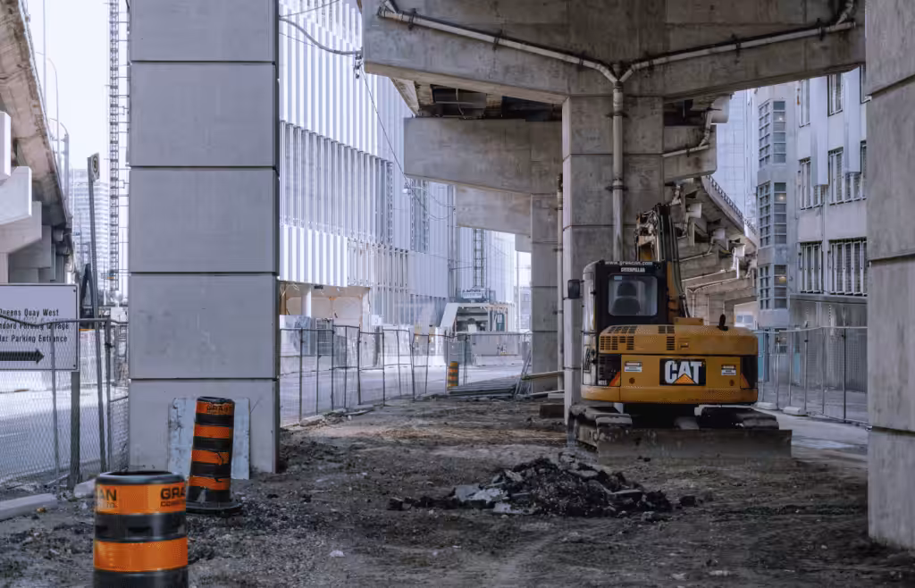 A construction site under an elevated roadway. DLP Meaning