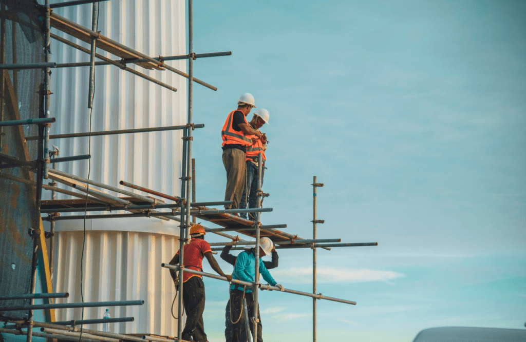 Construction workers working on scaffolding. Risk Management in Construction Projects