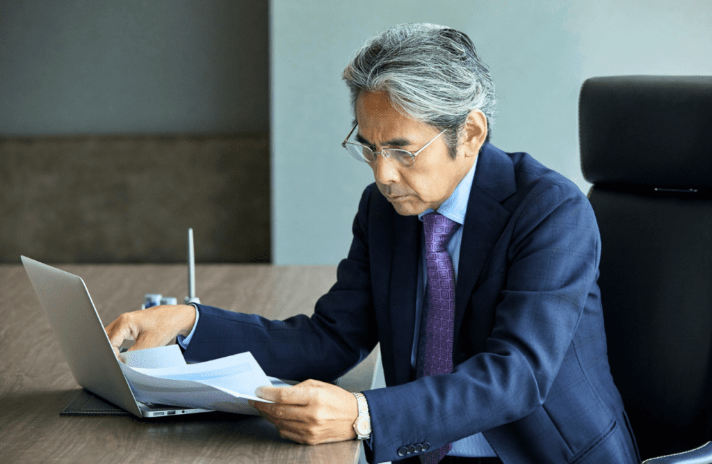 Blaze Business & Legal - How to Review a Contract 7 Businessman sitting in the office while reading a contract. How to Review a Contract