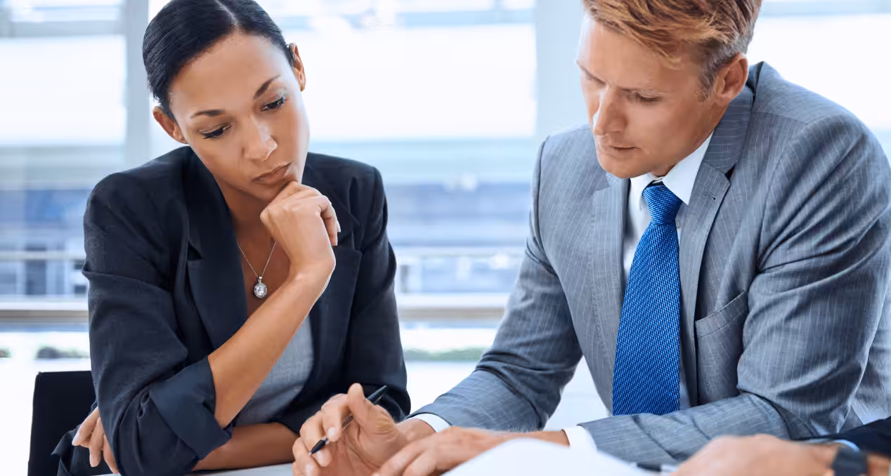 Two business people reading the contract before signing it. How to Review a Contract. Contract Review Lawyer