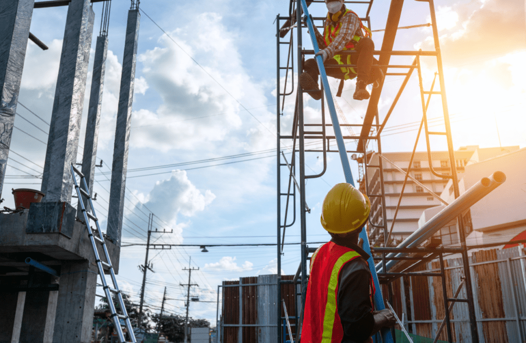 Construction Contract Review | Get Expert Legal Insights & Protect your Building Company 3 Two men working on scaffolding at a construction site. Design and Construction Contracts. Construction Contract Review
