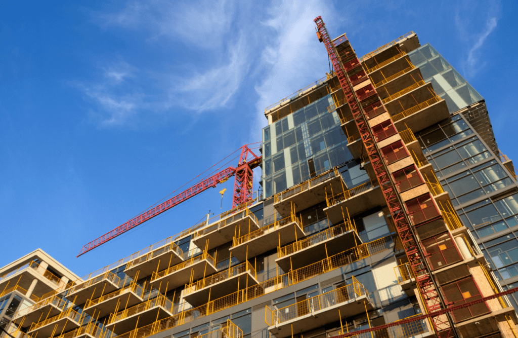 Your Design and Construct Contract Explained – How the D&C Contract Model Works in Australia 5 An under-construction building with a crane. Design and Construction Contracts