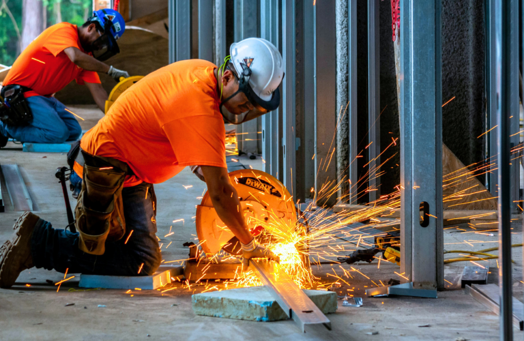 Your Design and Construct Contract Explained – How the D&C Contract Model Works in Australia 4 Construction workers doing a metal work. Design and Construction Contracts