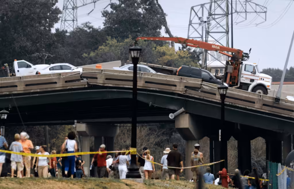 A collapsed bridge with vehicles on top. DLP Meaning