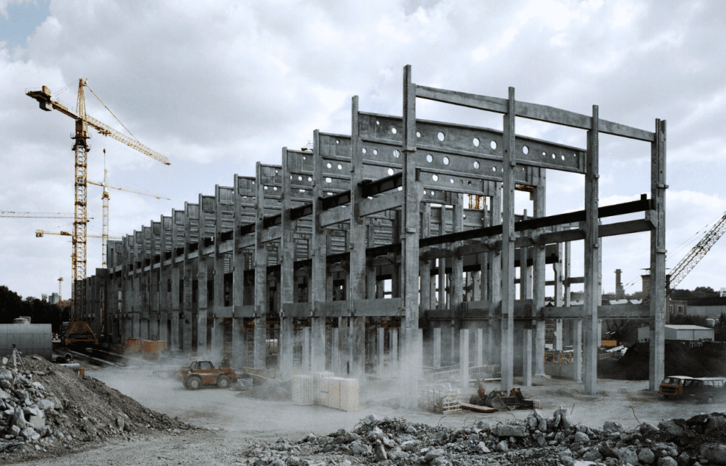 DLP Meaning – What is the Defects Liability Period in Construction? 14 Construction site with concrete pillars and scaffolding surrounding the structure. DLP Meaning
