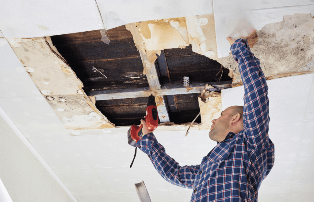 DLP Meaning – What is the Defects Liability Period in Construction? 10 Man repairing a collapsed ceiling. DLP Meaning