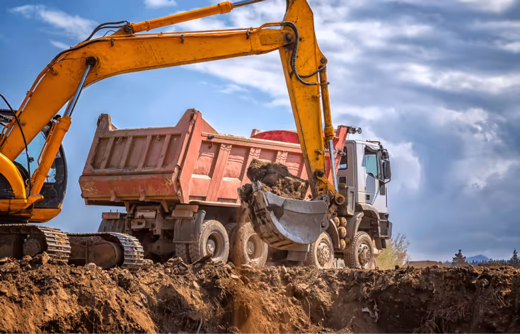 Excavator and dump truck are at work at a construction site. Latent Conditions