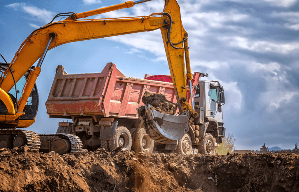 Excavator and dump truck are at work at a construction site. Latent Conditions