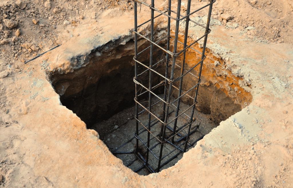 A hole in the ground with a metal frame. Latent Conditions