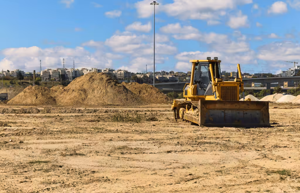 A bulldozer parked in a construction ground. Latent Conditions
