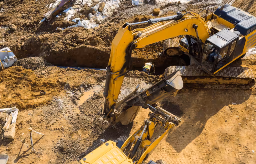 Heavy construction equipment digging into the ground. Latent Conditions
