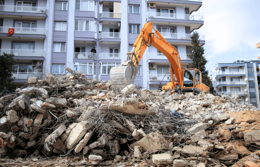 A large pile of debris in front a building. Latent Conditions