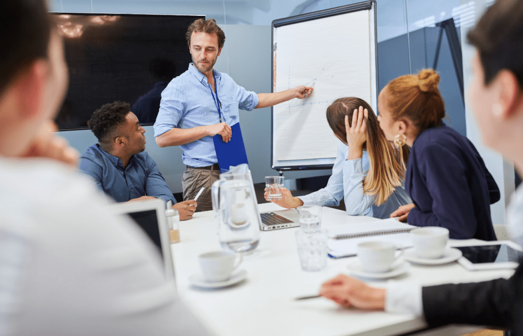 Consultant standing in front of clients. Management Consulting Companies Australia