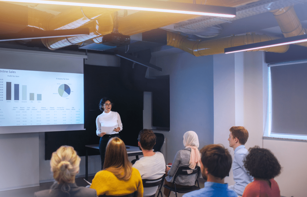Woman delivers a presentation in from of her clients. Management Consulting Companies Australia. How to Protect your Clients