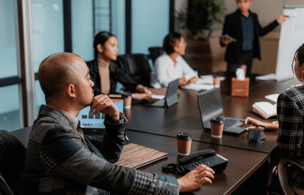 What is the Management Consulting Industry – A Practical Guide for Australian Businesses 7 Client listening to Management Consultant's presentation. Managment Consulting Industry