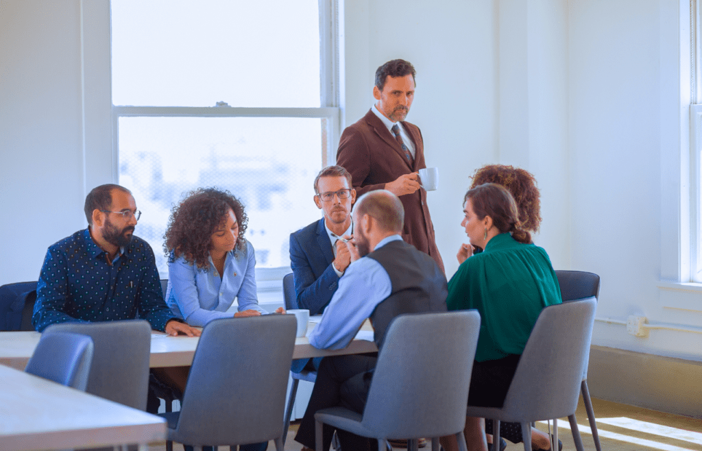 What is the Management Consulting Industry – A Practical Guide for Australian Businesses 8 Group of business people inside a meeting room. Managment Consulting Industry