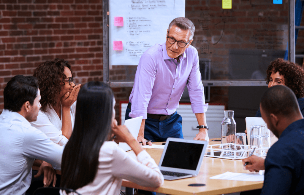 What is the Management Consulting Industry – A Practical Guide for Australian Businesses 9 Man leading a business meeting. Managment Consulting Industry