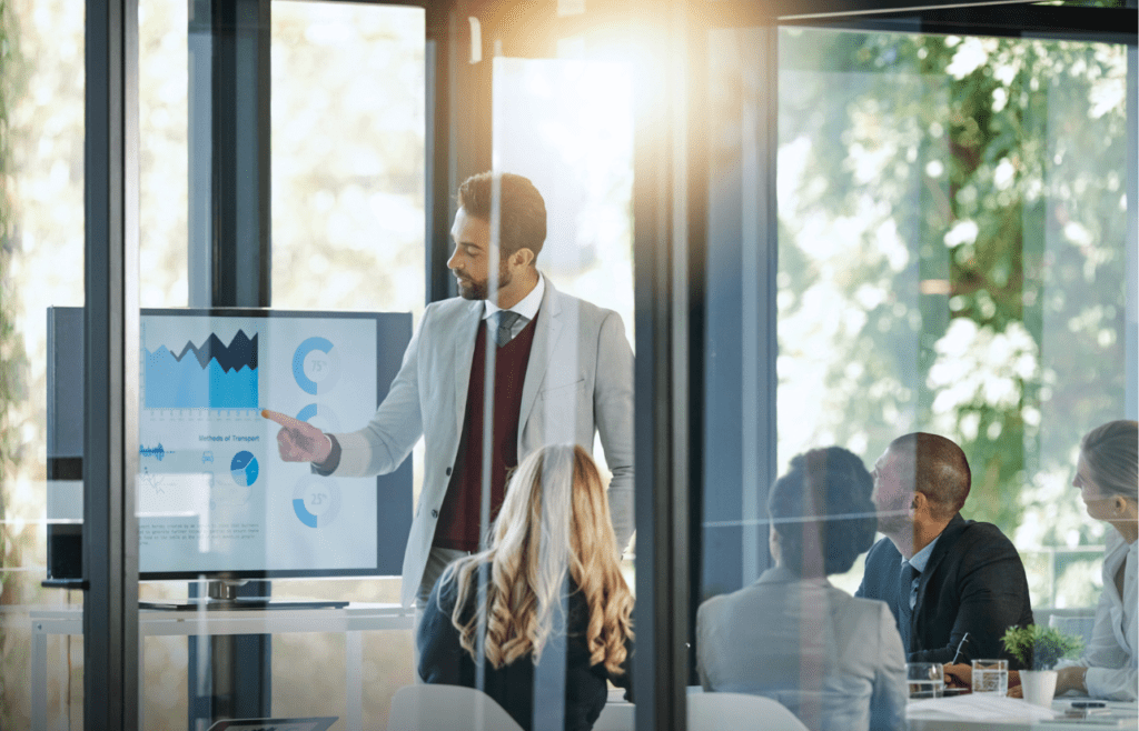 What is the Management Consulting Industry – A Practical Guide for Australian Businesses 14 Audience listening to man presenting in front. Managment Consulting Industry. How to Protect your Business