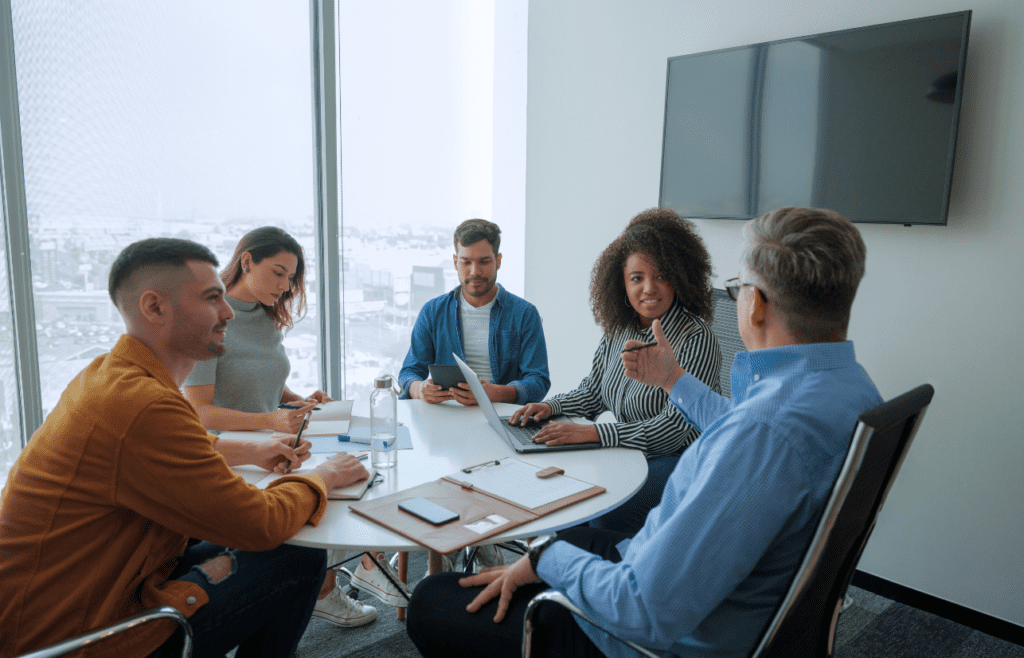 What is the Management Consulting Industry – A Practical Guide for Australian Businesses 15 Manager and employees having meeting in board room. Managment Consulting Industry