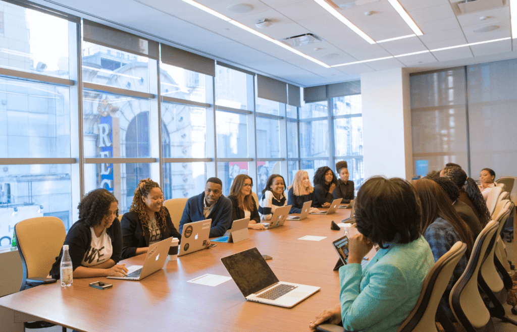 Diverse group of professionals sitting around a conference table. Management Consulting Companies Australia
