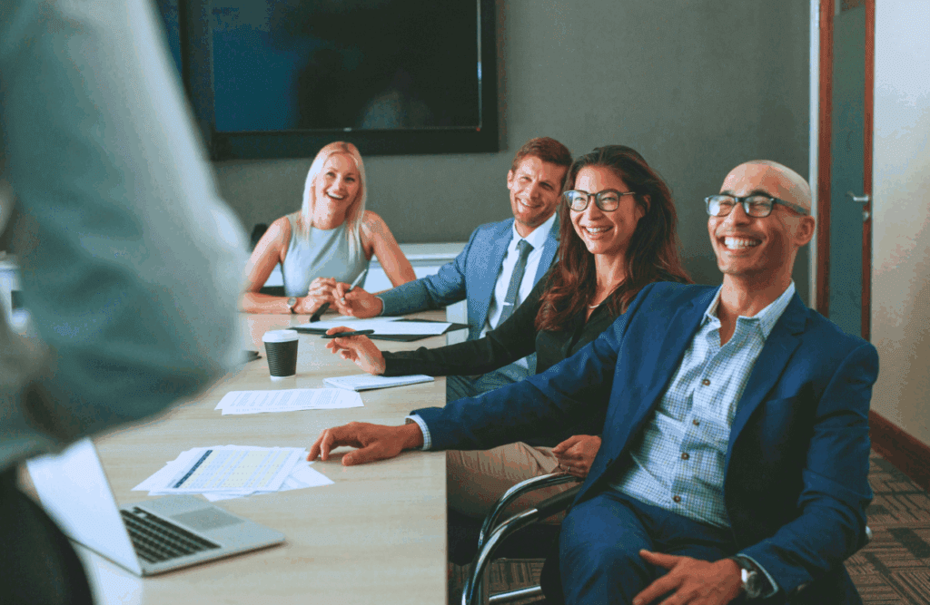 Business team members seated at a conference table. How to Protect your Business