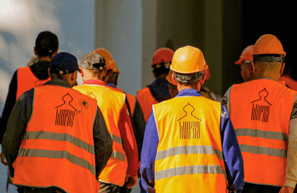 Construction workers wearing safety vests. Construction and Contracting