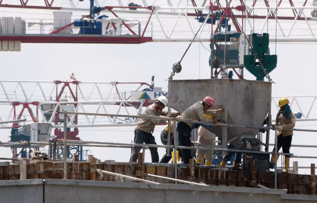 Contruction workers working together at a construction site. Construction and Contracting