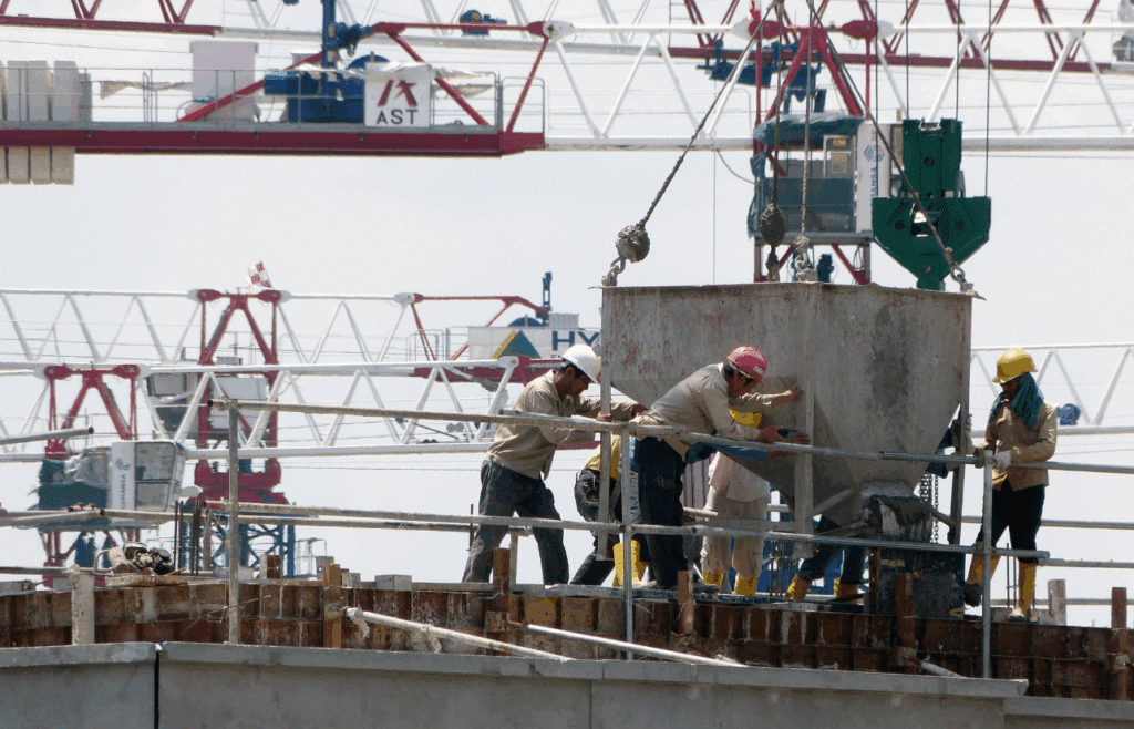 Contruction workers working together at a construction site. Construction and Contracting