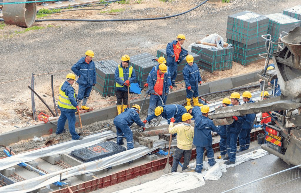 Construction Workers working on light rail tracks. Construction and Contracting
